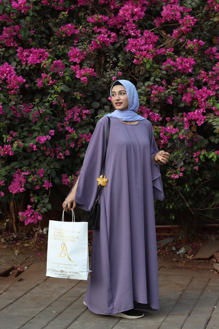 Woman in a lilac abaya with sky-blue hijab