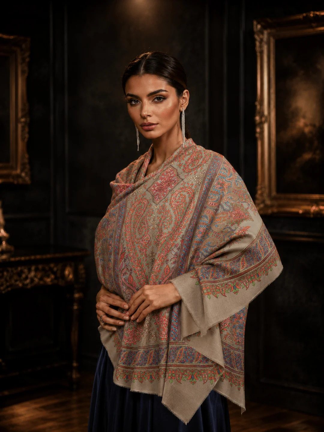 Woman styling a paisley pashmina shawl in an editorial setting